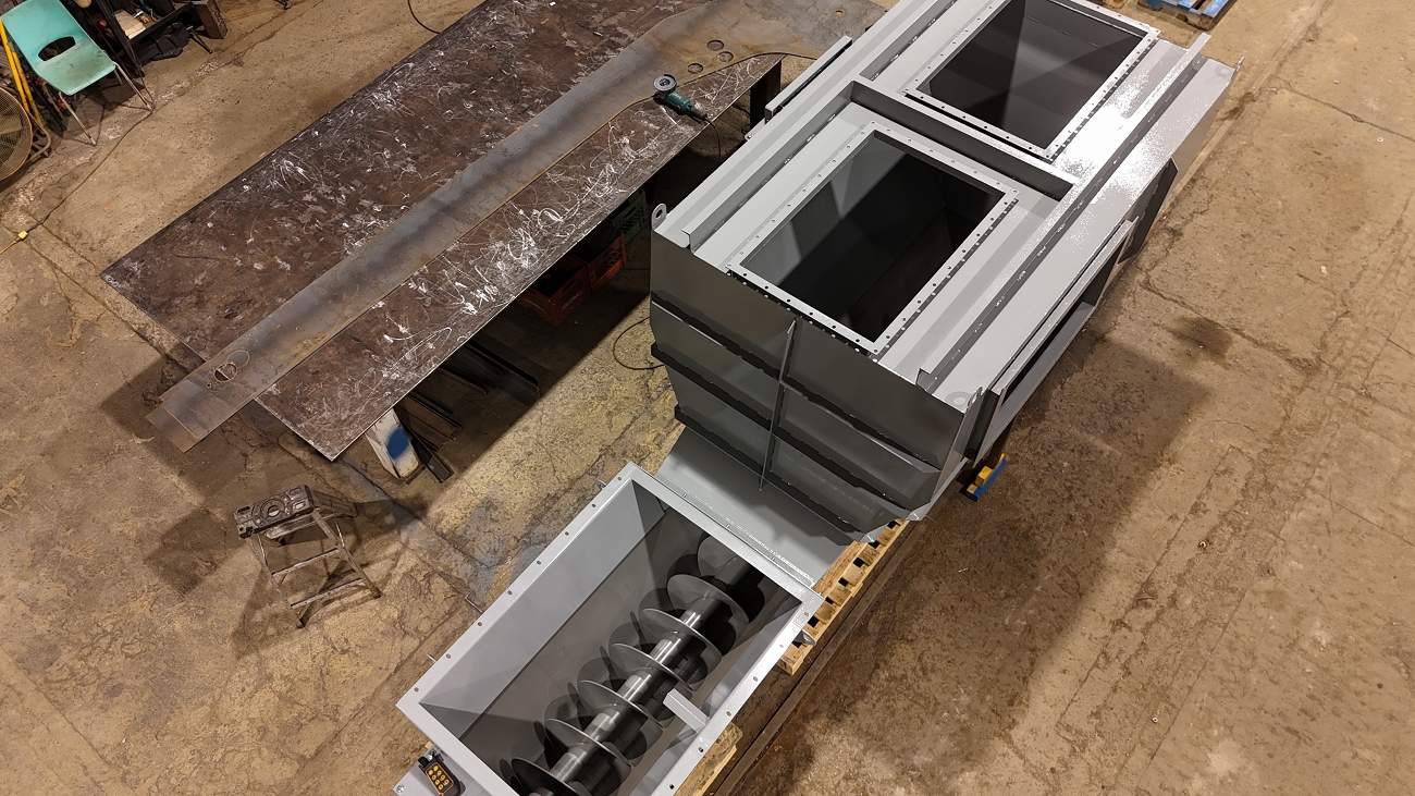 Grey custom screw conveyor and feeder manufactured in Canada, showing full assembly