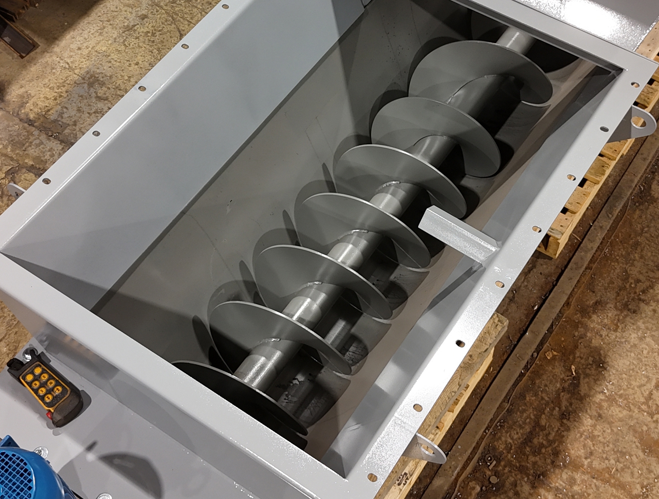 Screw flighting and trough detail on a custom screw conveyor feeder